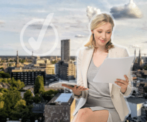Happy woman holding BSN papers with an aerial photo of Eindhoven in the background.